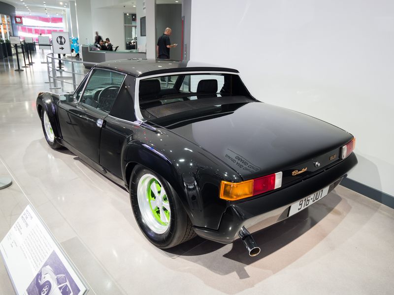 Black Porsche 916 Brutus from the rear left, showing the gold Brutus script on the engine lid, the body-colour rear bumper and a 916-001 plate