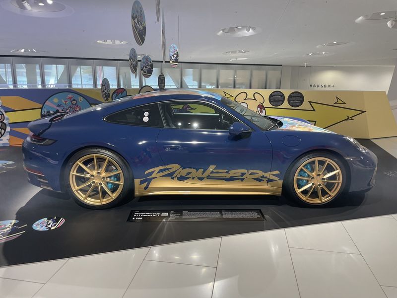 Blue and gold Porsche 911 Carrera exhibit at the Porsche Museum