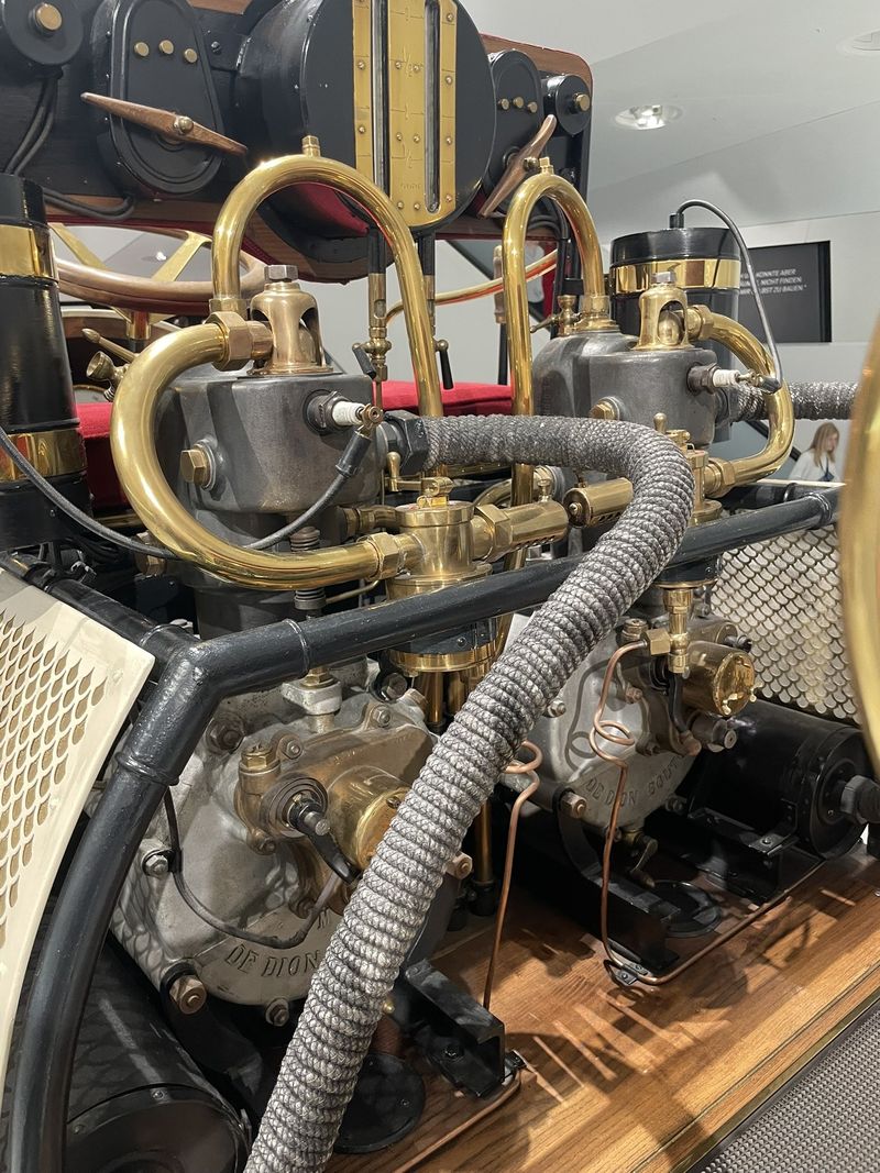 Brass-fitted De Dion-Bouton engines on the Lohner-Porsche Semper Vivus hybrid at the Porsche Museum
