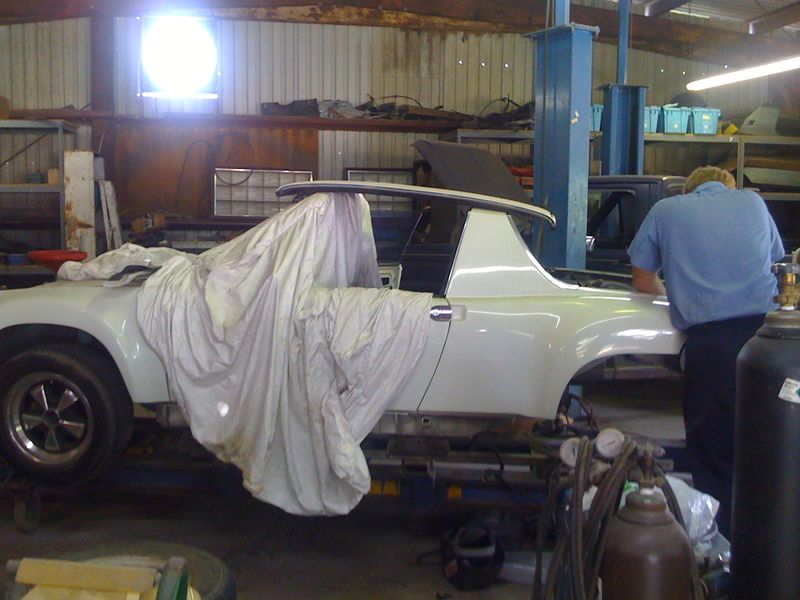 Right rear quarter panel removed, exposing the engine compartment